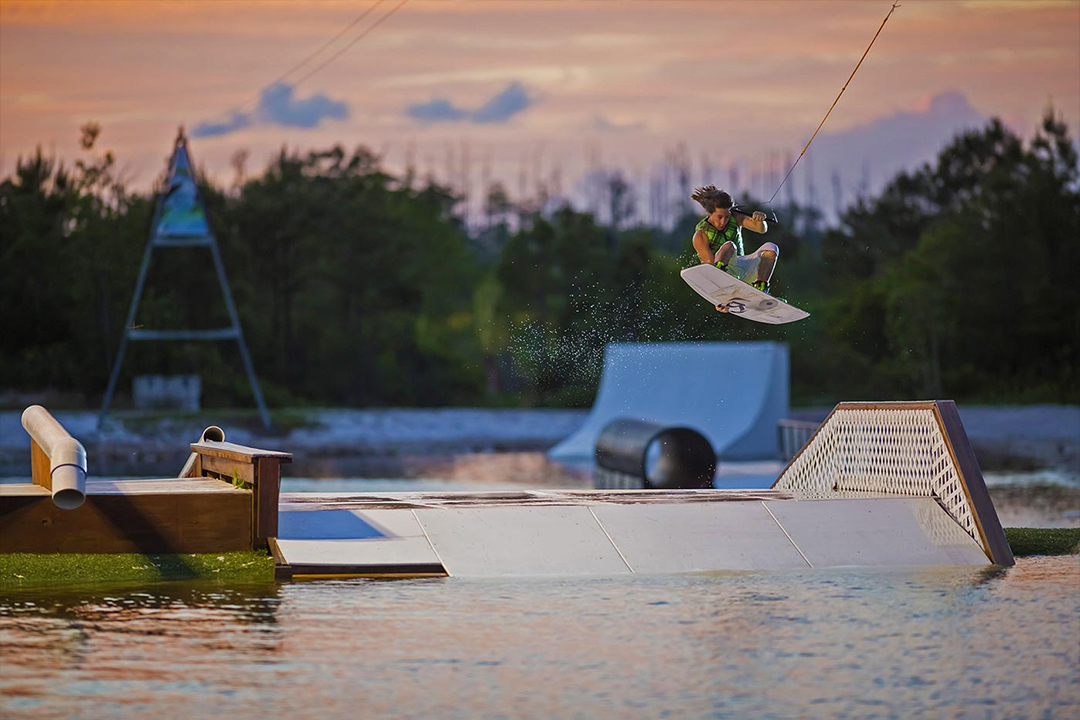 wake boarder hitting a ramp from Shark Wake Park