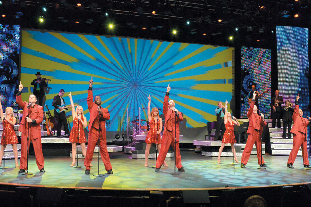 9 singers and dancers on stage performing at Alabama Theatre