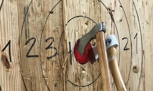 axe stuck in the middle of bulls-eye of target