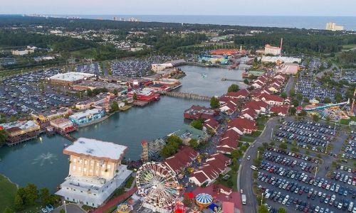 airel image of Broadway at the beach with shops and lake