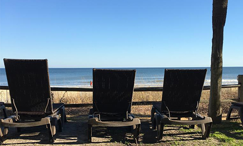 2 beach chairs facing ocean