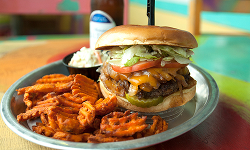 Plate with a burger and fries from River City Cafe