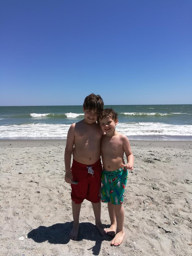 Brothers posing for a photo on the beach