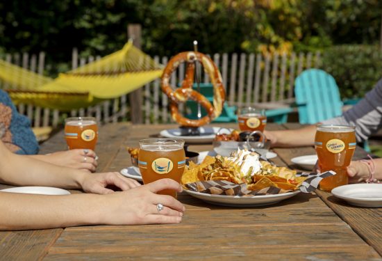 People at the crooked hammock brewery with beers