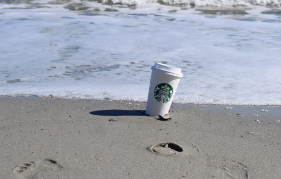 starbucks cup on the beach