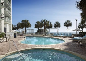 The outdoor pool with the hot tub on a sunny day