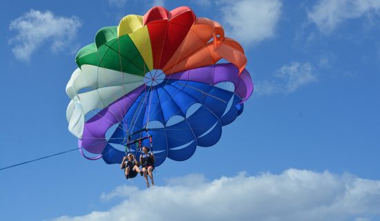 Couple parasailing over the ocean Couple parasailing over the ocean
