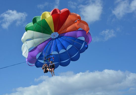 Couple parasailing over the ocean