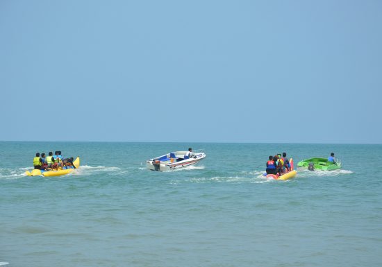 Families on banana boats in the ocean
