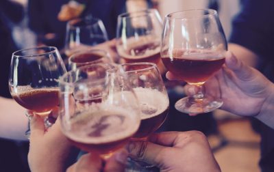 Glasses cheersing Glasses of alcohol cheersing with friends