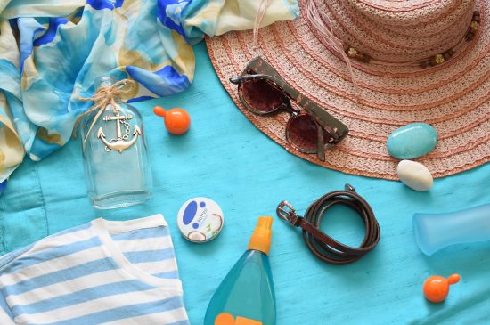 Beach essentials laying on towel