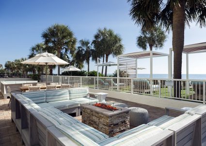 Couch around the fire pit on the pool deck